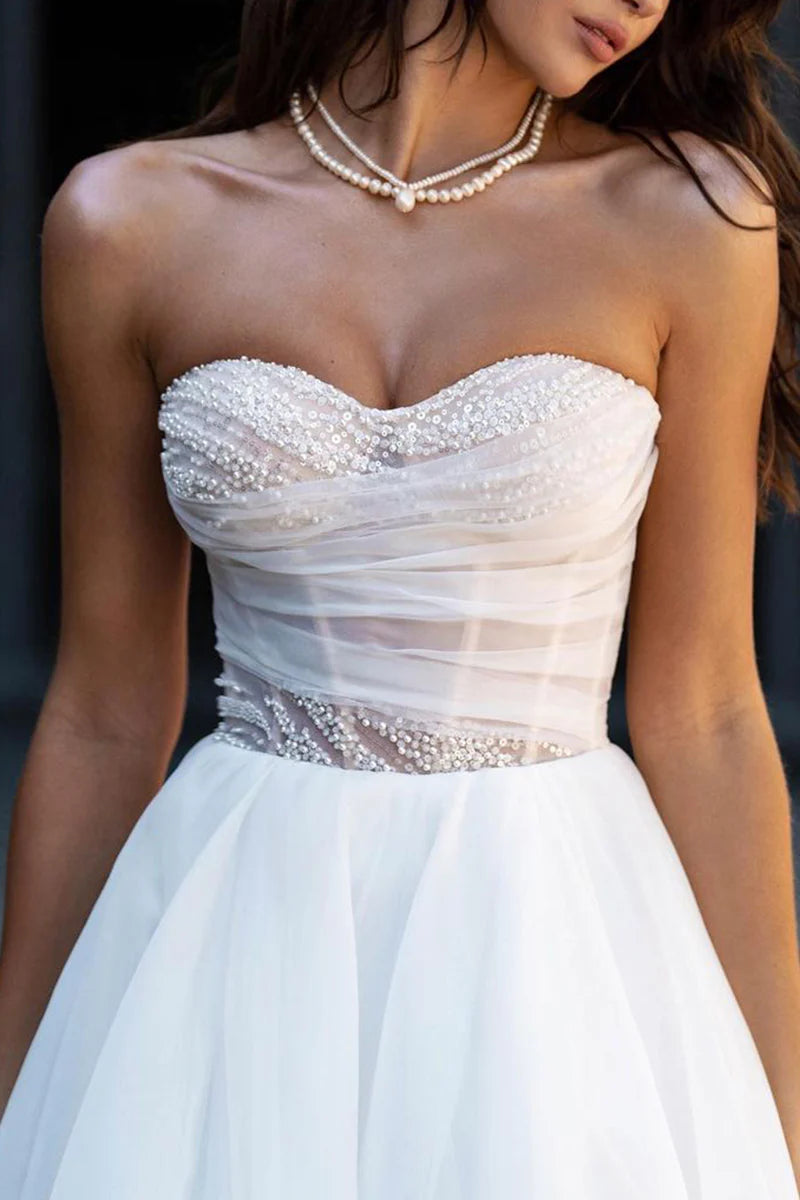 Full length view of a bride wearing an A-line sweetheart wedding dress.