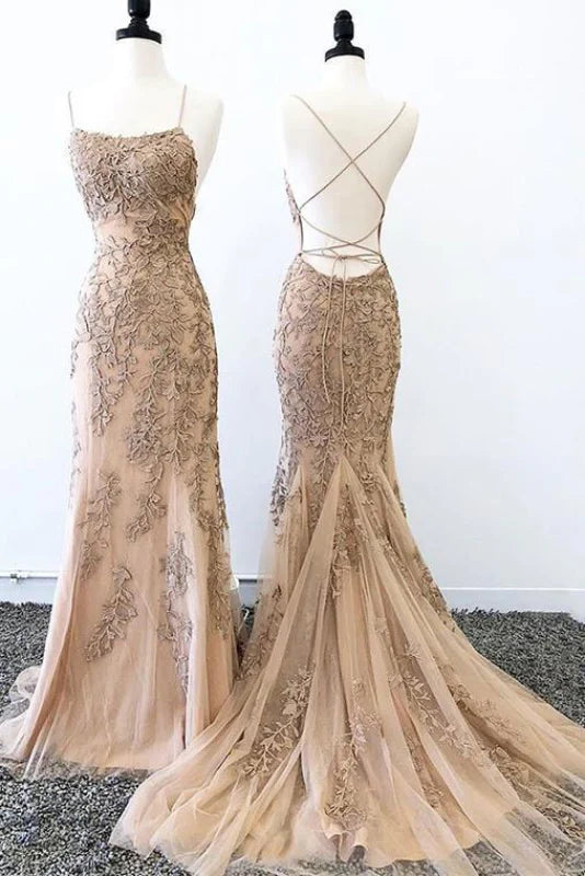 Woman wearing a sleeveless mermaid prom dress with a criss-cross back.