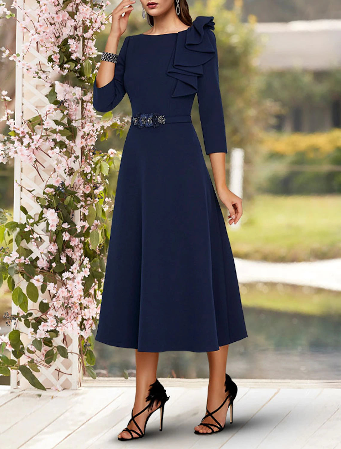 Back view of the A-line tea length dress, showcasing the elegant silhouette and stretch fabric.