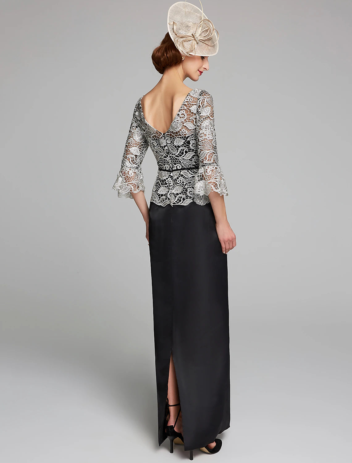 Close-up of the jewel neckline and lace bodice of the dark blue dress.
