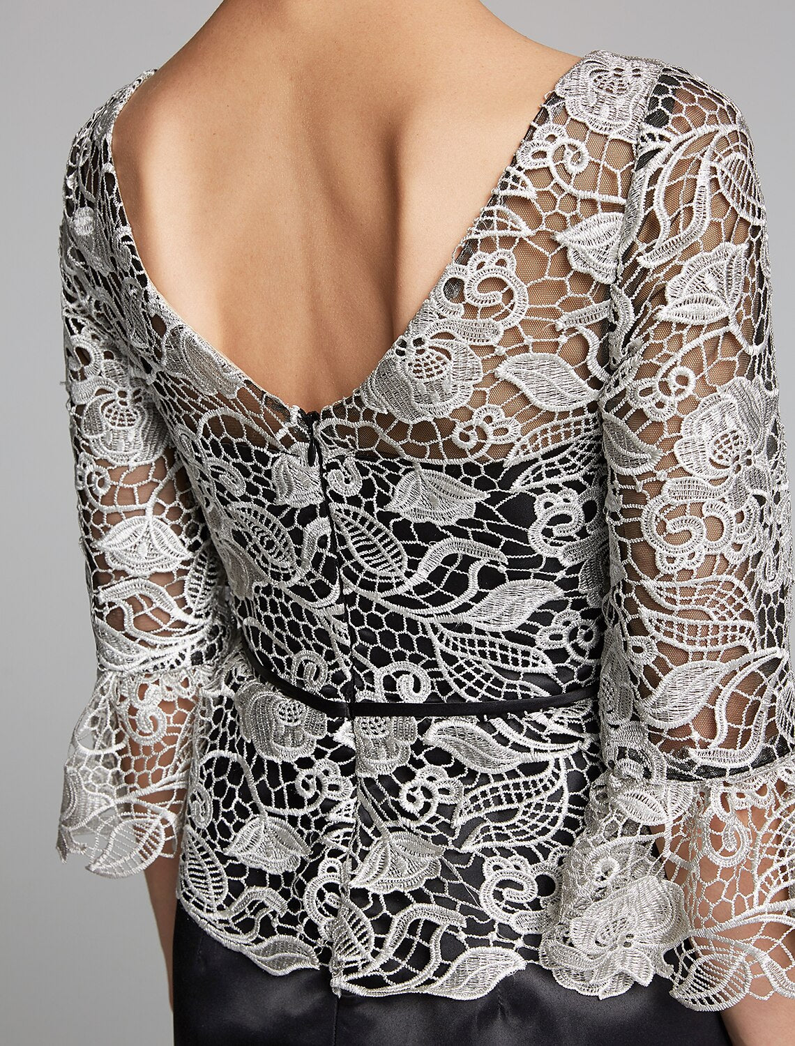 Side view of the dark blue formal gown with lace sleeves.