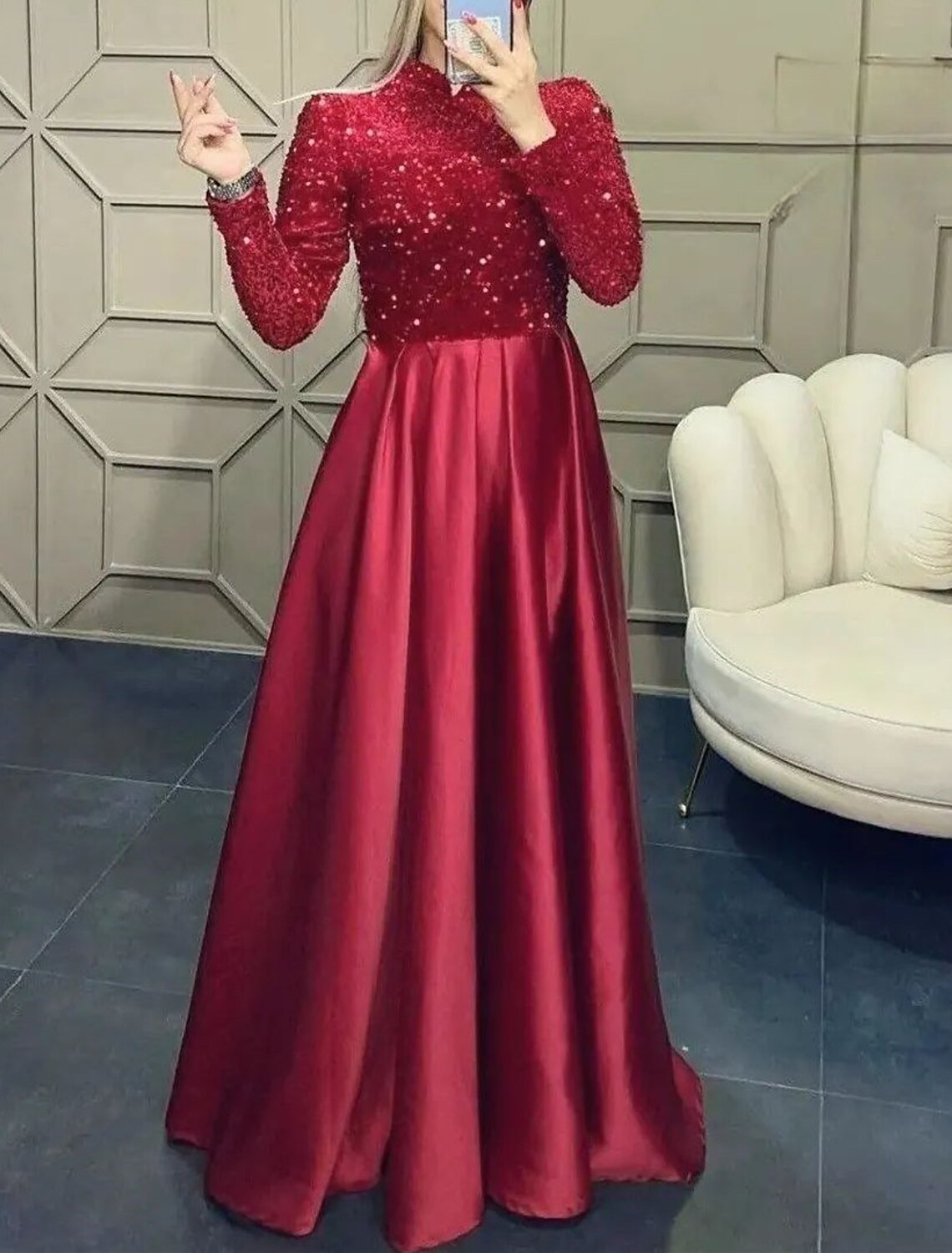 Full length view of a red A-line formal dress with long sleeves.