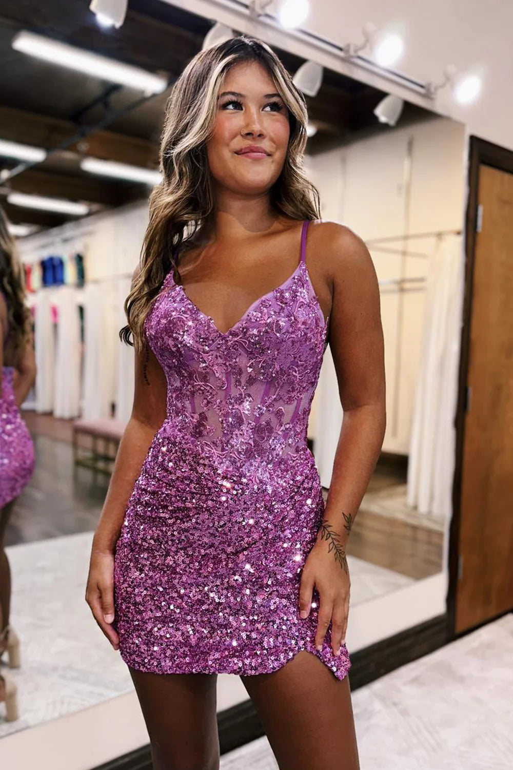 Model showcasing the glitter bodycon mini dress from a different angle.
