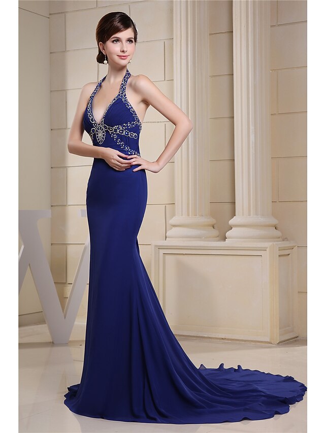 Back view of a mermaid evening gown showing chapel train and halter neckline.