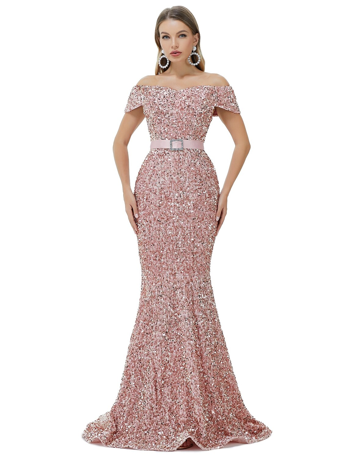 Woman wearing a sparkling off-shoulder mermaid gown with a court train.