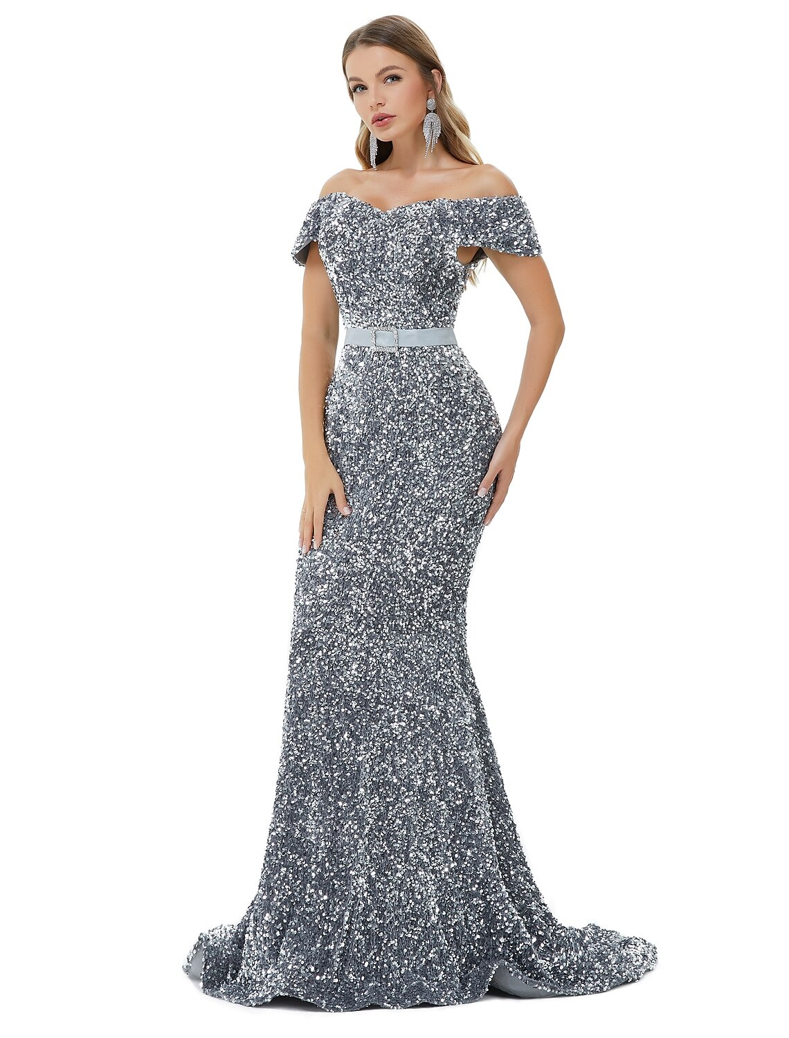 Woman posing in a shimmering mermaid evening dress.
