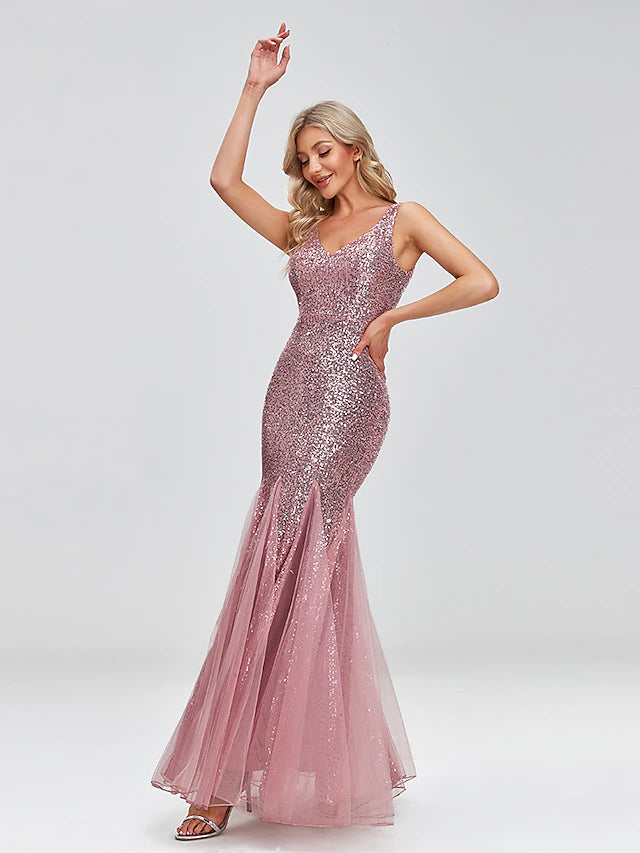 Back view of a woman in a sequin tulle floor-length evening dress.
