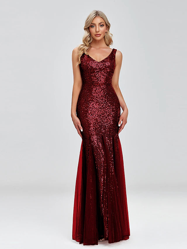 Side profile of a woman in a sleeveless sparkle evening gown.