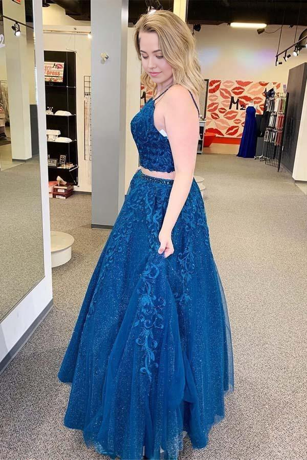 Full view of the royal blue formal gown featuring appliques and a flowing tulle skirt.