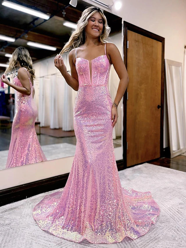Model wearing a sparkling mermaid trumpet prom dress with spaghetti straps and a V-back.