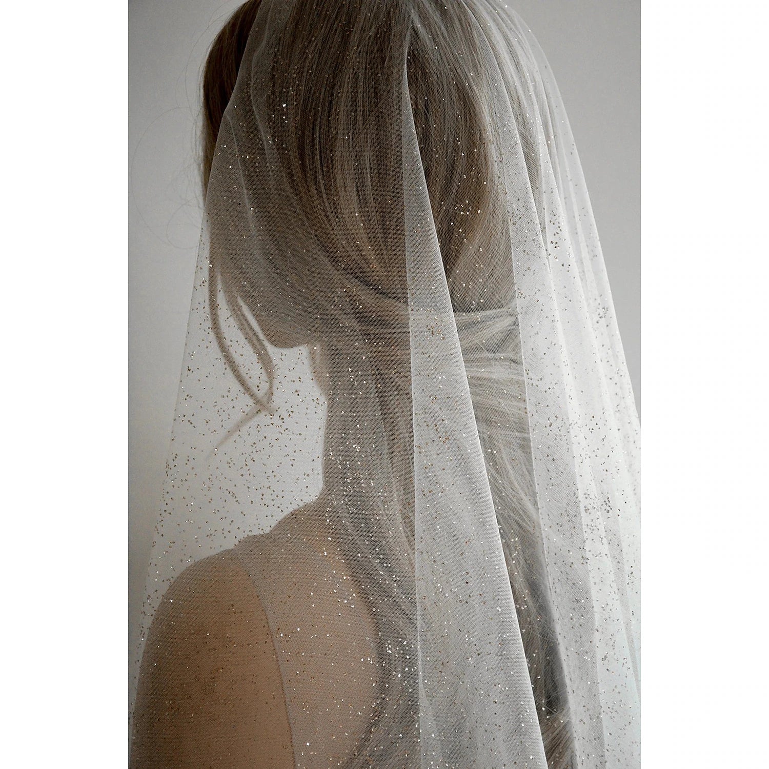 Flowing tulle cathedral veil with sequin embellishments.