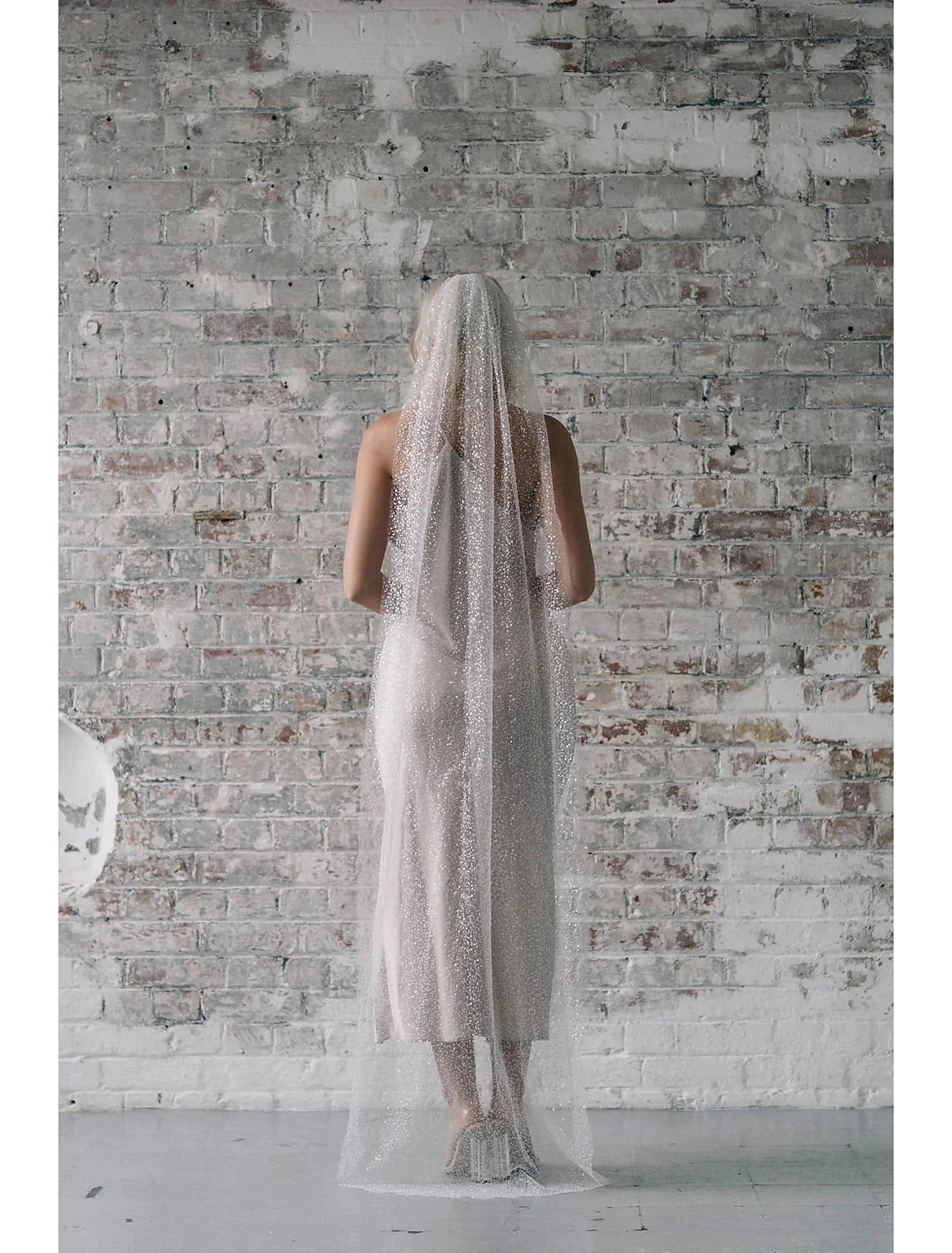 Elegant one-tier chapel wedding veil with sparkling sequin details.