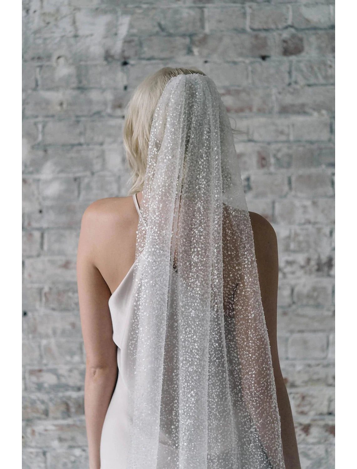Bridal chapel veil made of delicate tulle, adorned with shimmering sequins.