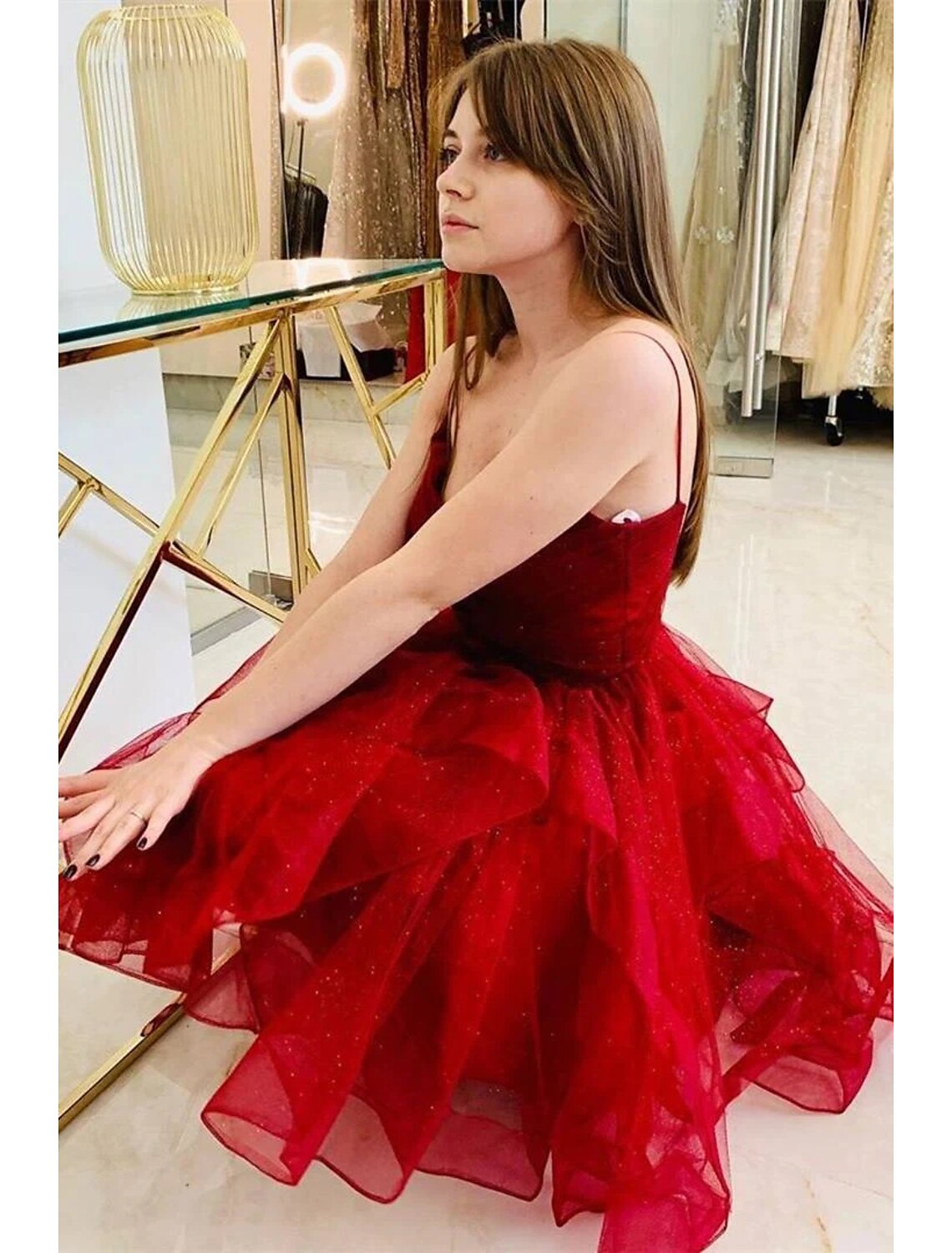 Back view of the A-line ball gown, highlighting the backless design and glitter tulle ruffles.