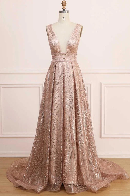 Woman wearing a sparkling A-line deep V-neck sequin glitter prom dress, full length view.