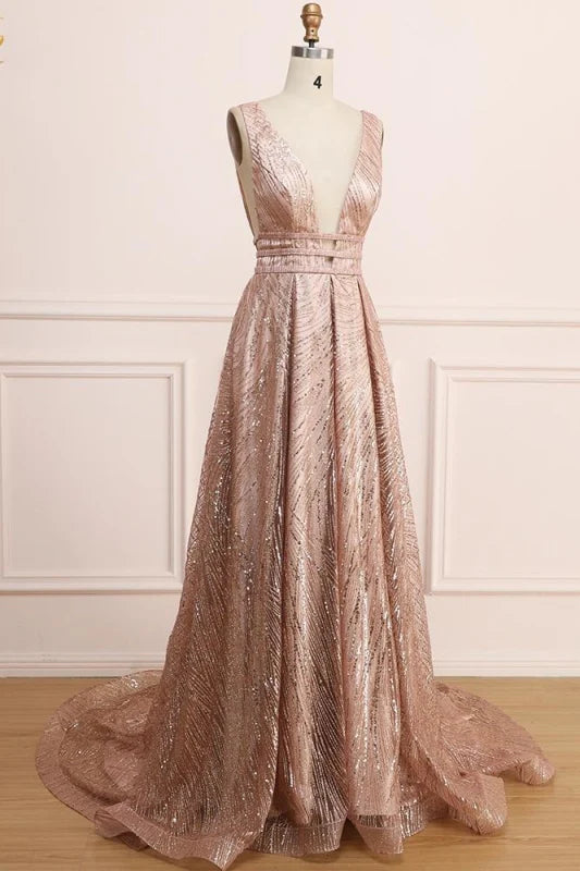 Back view of a woman wearing a sleeveless deep V-neck sequin prom dress.