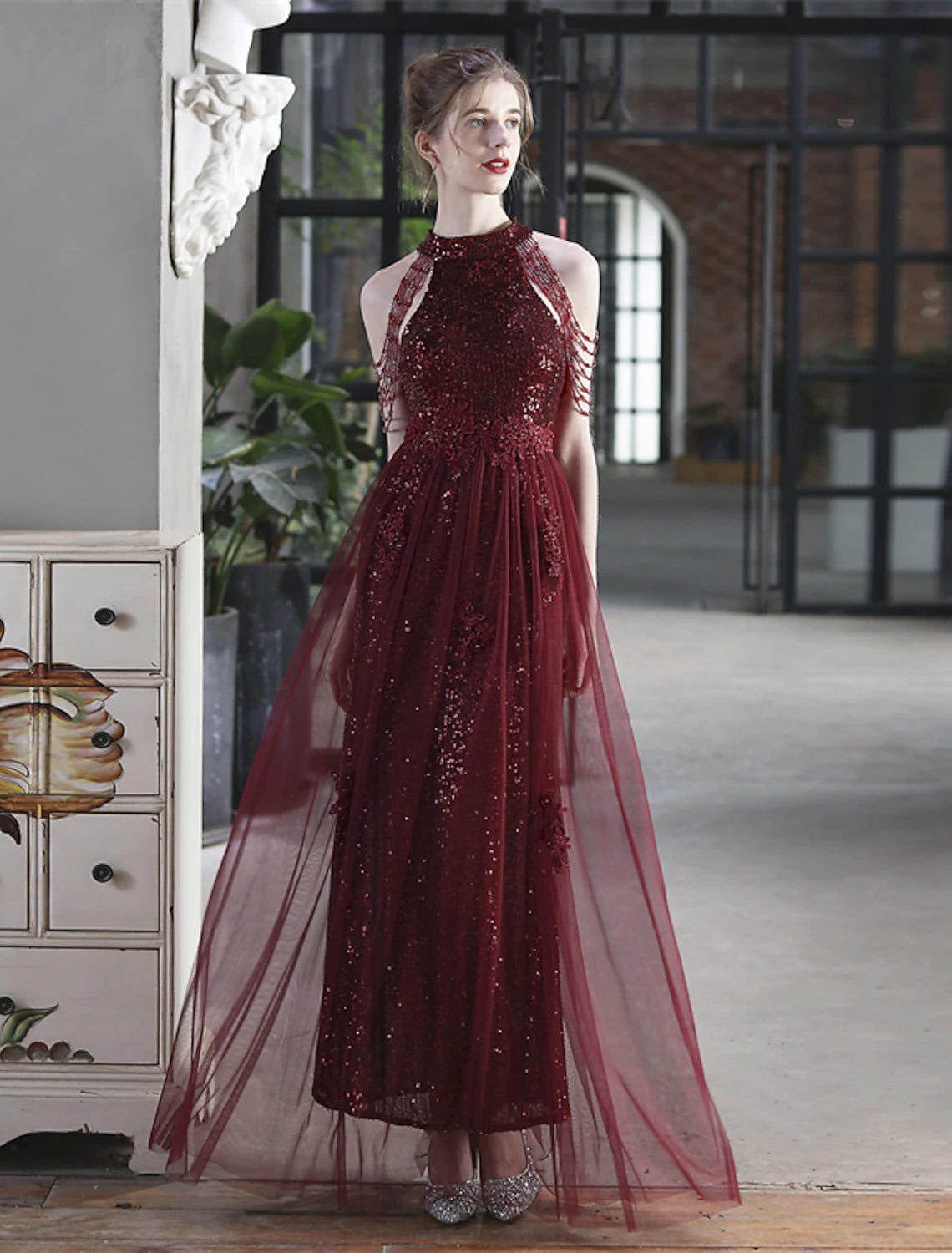 Back view of a floor-length sequin A-line dress.