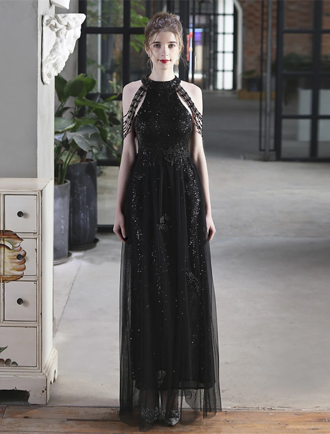 Side profile of a woman wearing a high neck sequin prom dress.