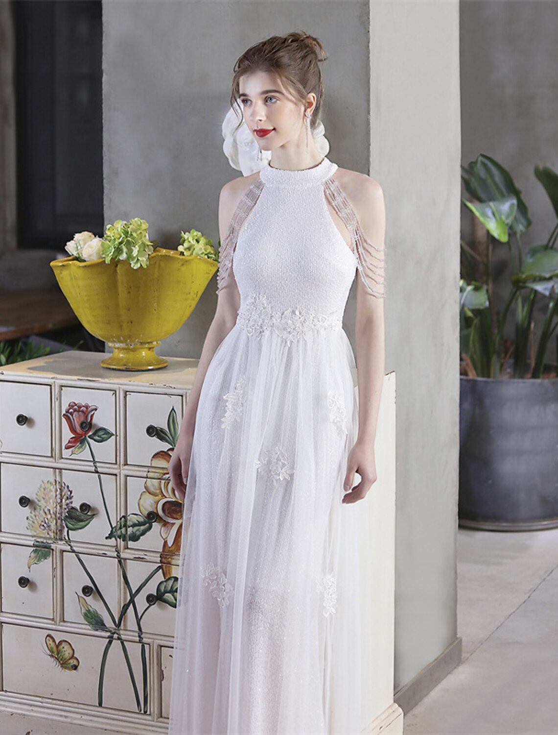 Full view of a sparkling A-line gown with high neckline.