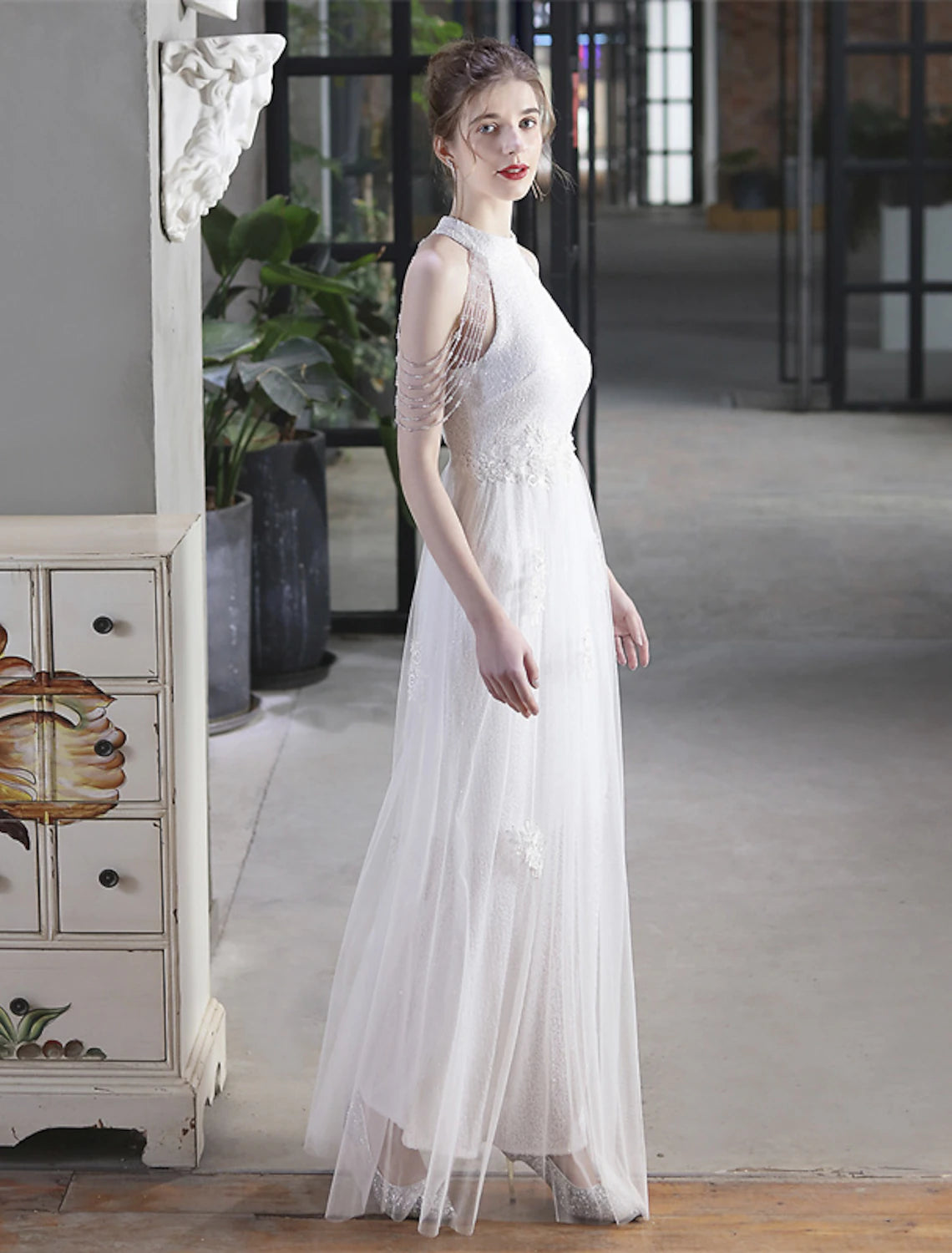 Detail of the high neck and short sleeve design on a sequin dress.