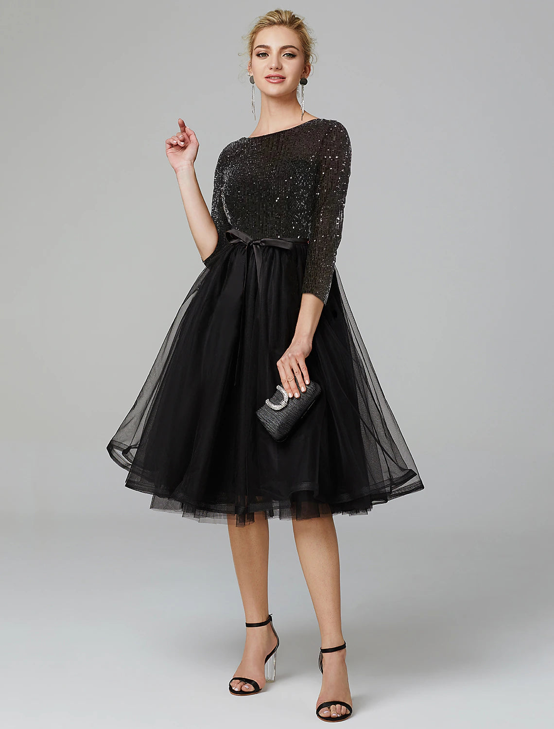 Sparkling A-line cocktail dress with jewel neck and 3/4 sleeves.