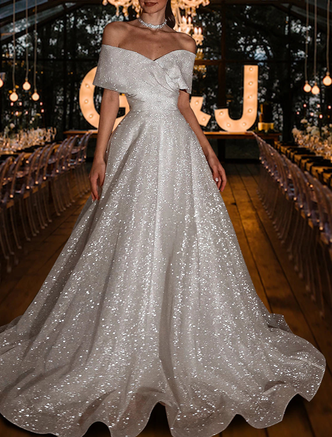 Side view of the sparkling off-shoulder bridal gown.