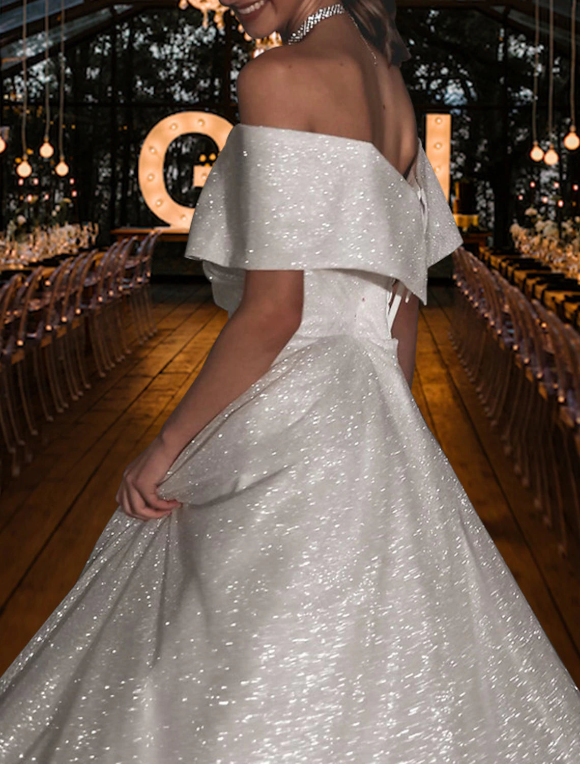 Model wearing the A-line off-shoulder sequined wedding dress.
