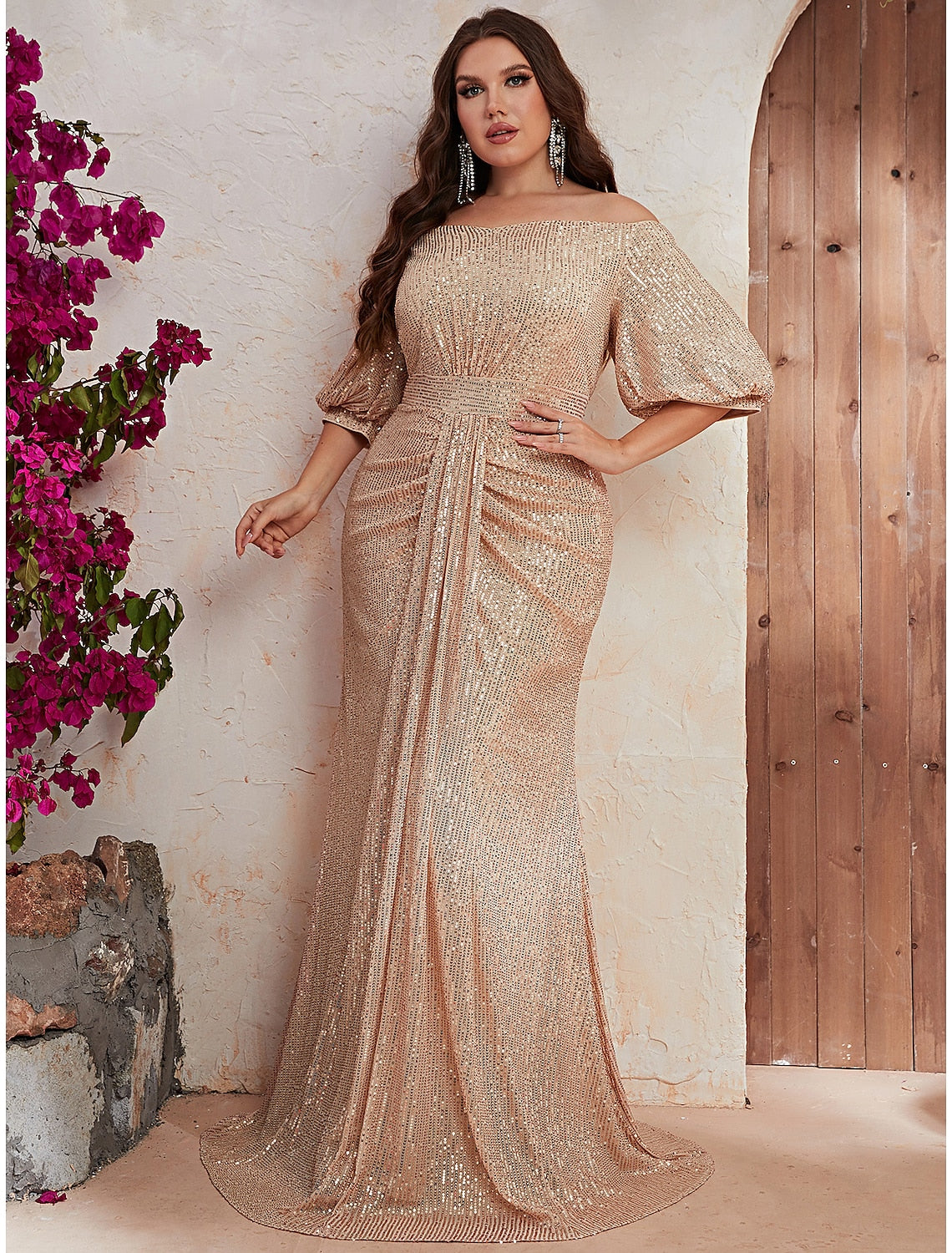 Side view of sparkling A-Line off-shoulder half sleeve beaded formal wedding guest gown.