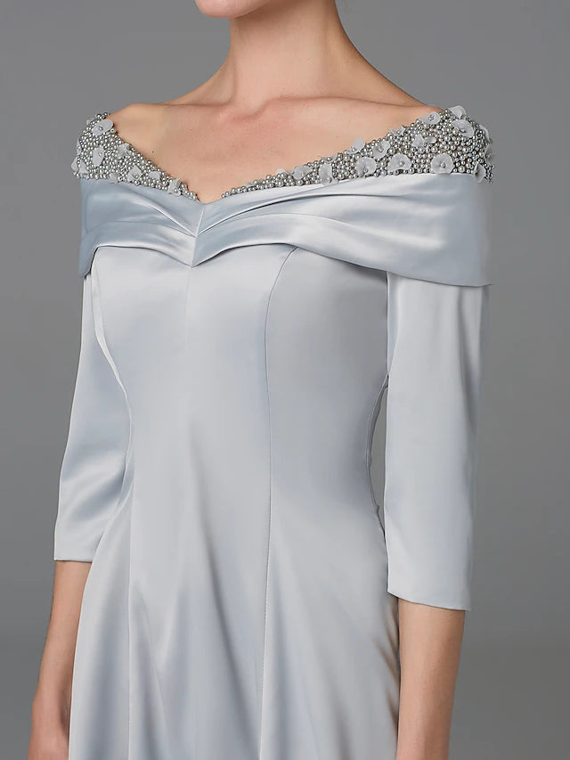 Close-up of the lace and crystal embellishments on the satin dress.