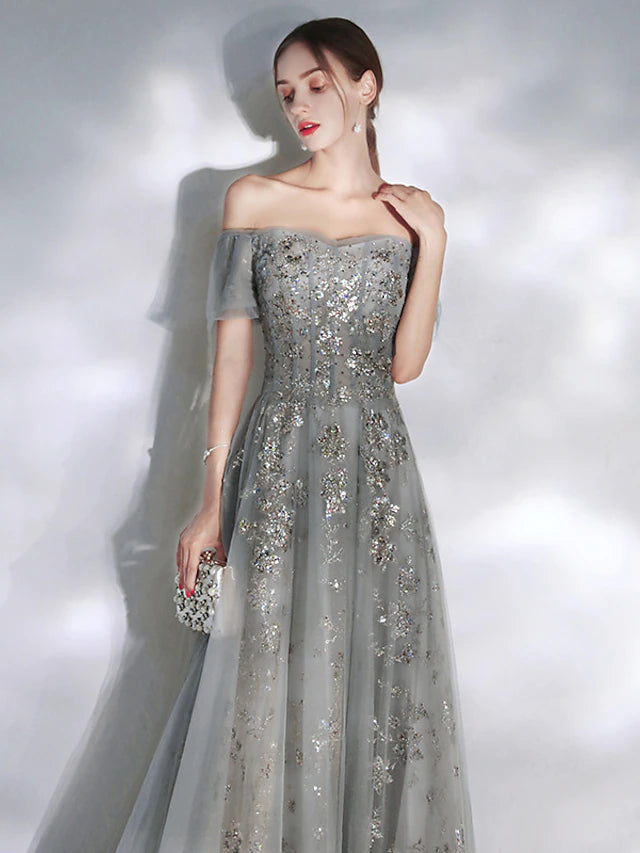 Detail view of the elegant off-shoulder neckline and short sleeve design.