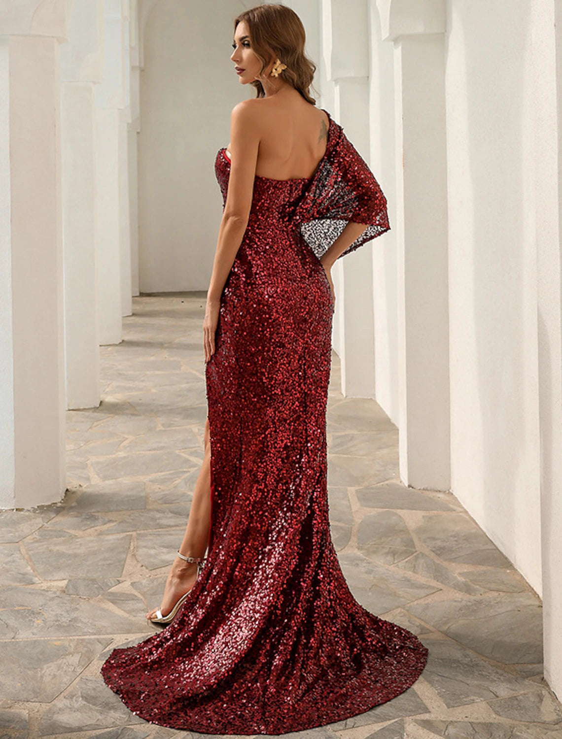 Detail of the one-shoulder neckline on the sequined evening dress.