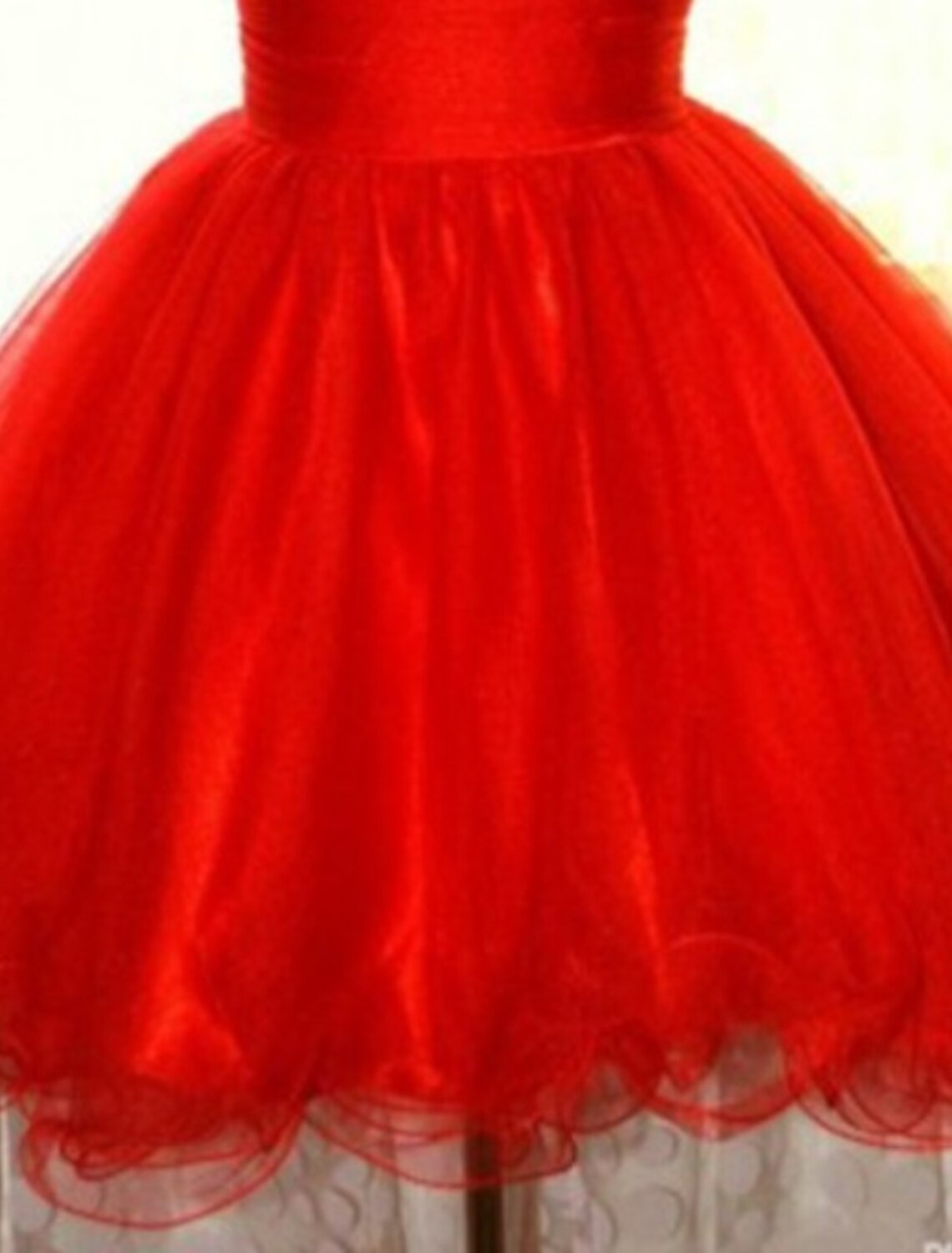 Close-up of the sequin and tulle fabric on the pink mini dress.