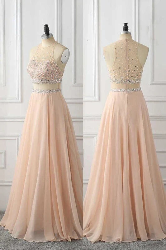 Woman wearing a sparkling A-line rhinestone chiffon long prom gown.