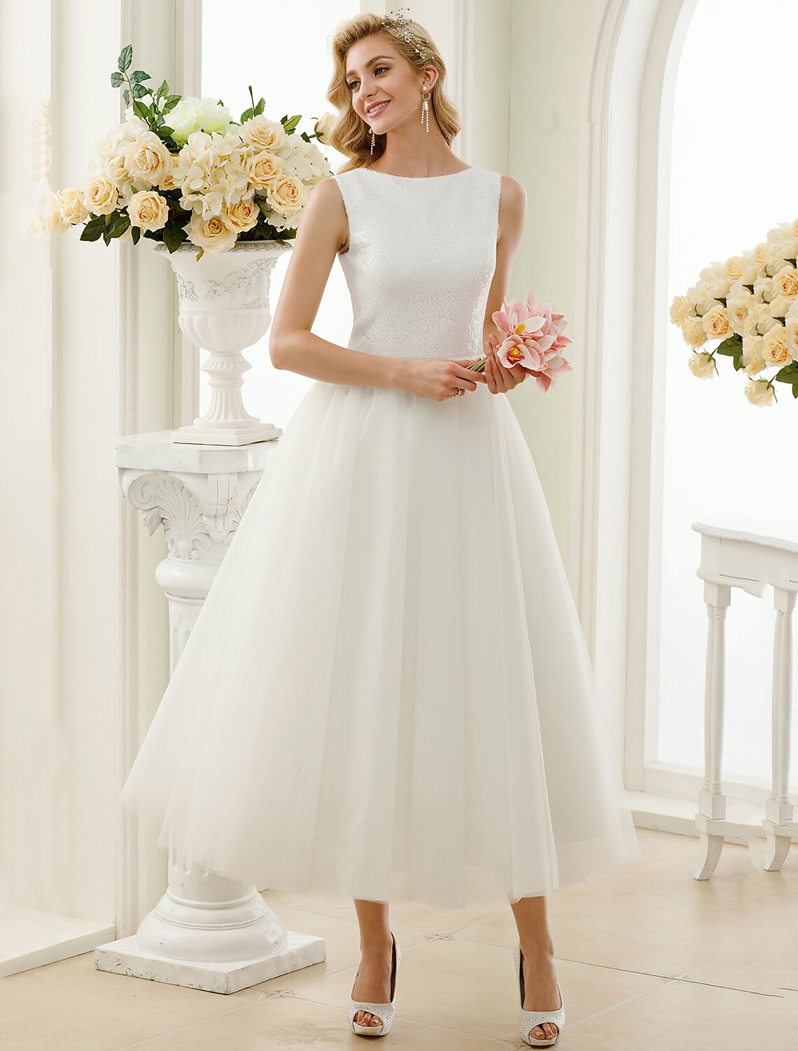Sparkling A-line tea length white wedding dress with lace sequin details.