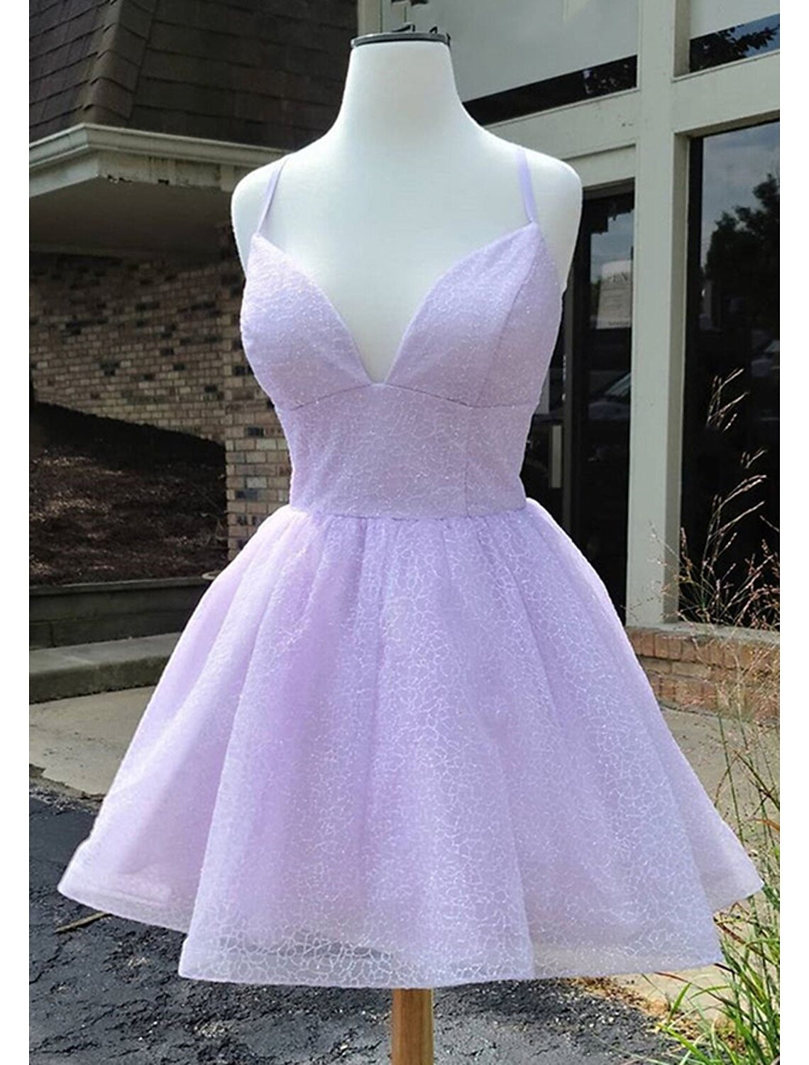 Front view of a sparkling A-line short homecoming dress with glitter tulle and spaghetti straps.