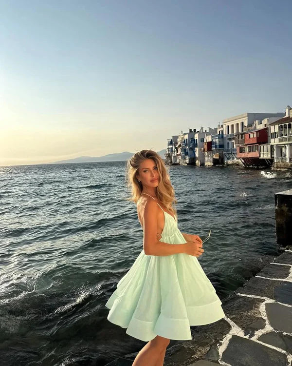 Sparkling short A-line dress with spaghetti straps, perfect for formal events.