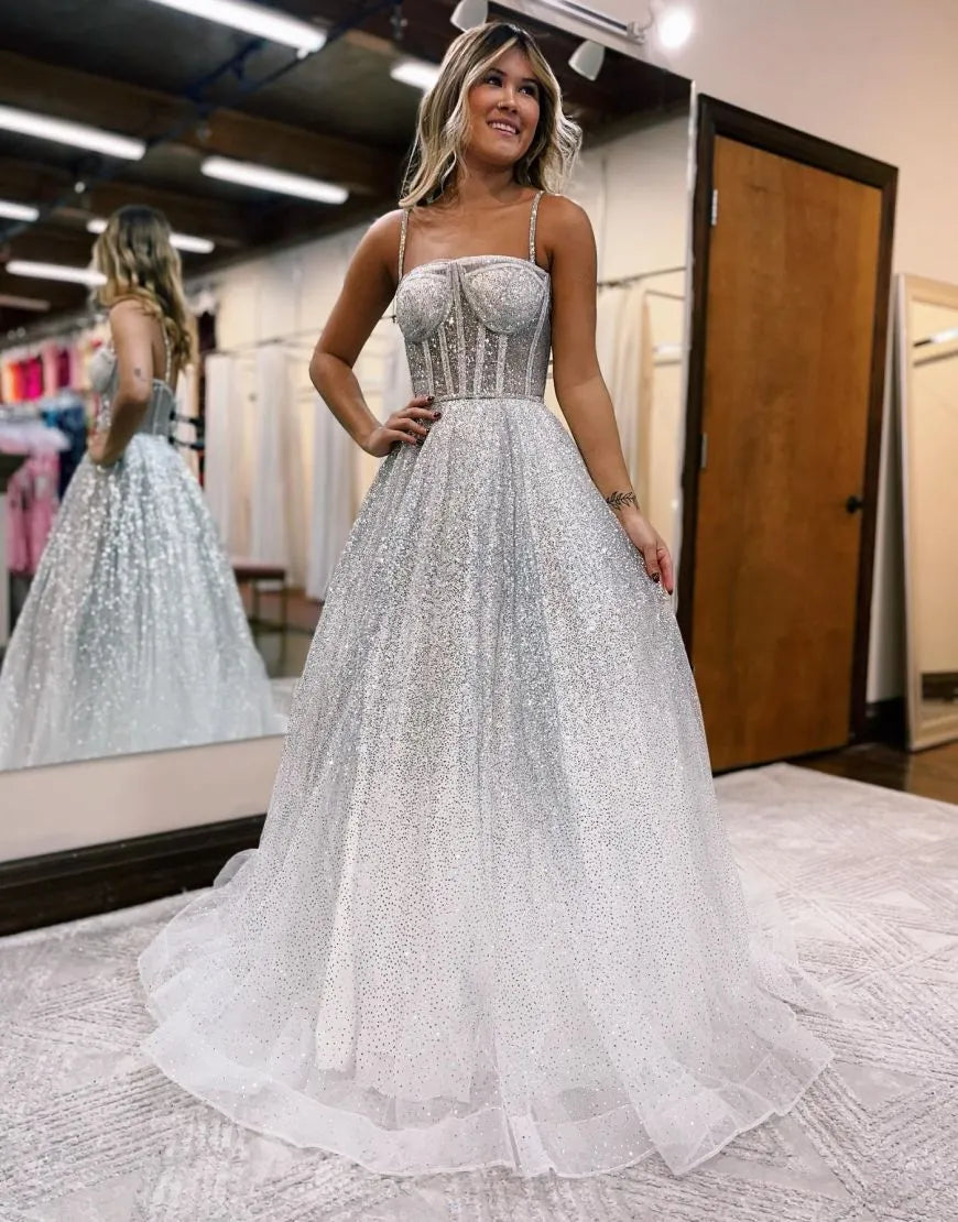 Front view of an A-line tulle organza wedding dress with spaghetti straps.