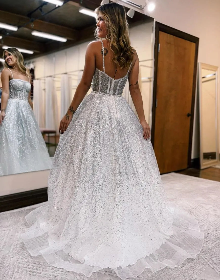Back view of an A-line wedding dress with spaghetti straps and flowing skirt.