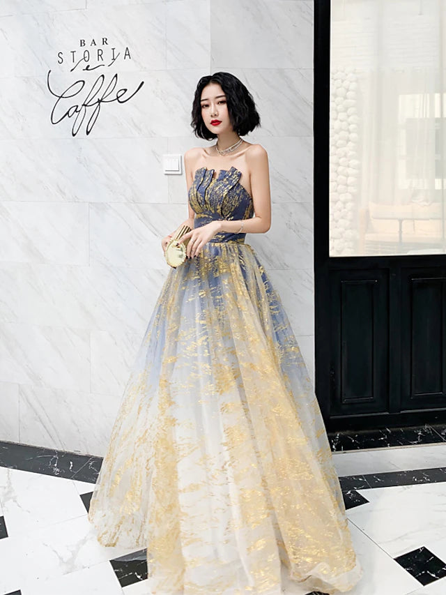 Full view of the model posing in the sparkling strapless floor-length gown.