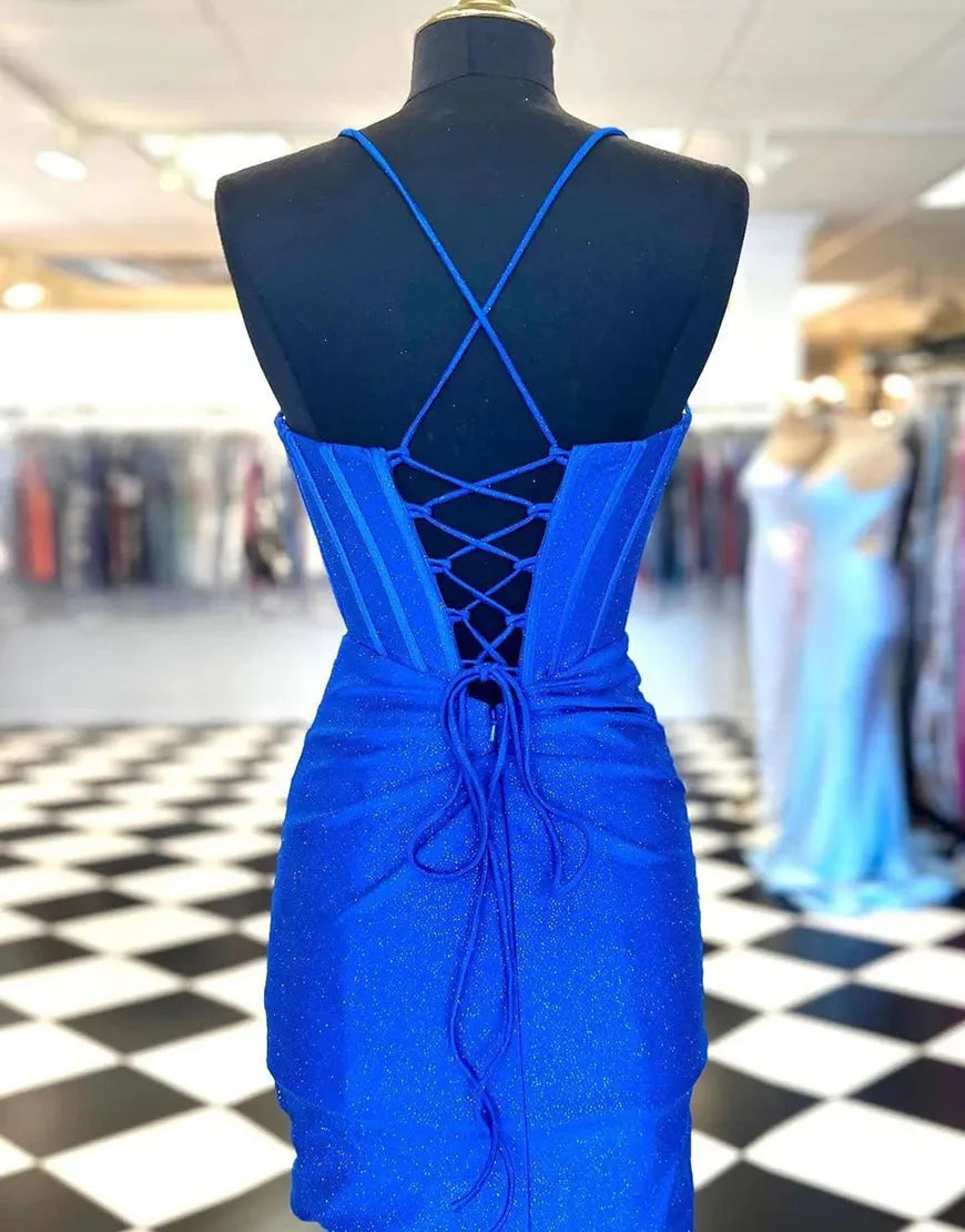 Model wearing a royal blue glitter short party dress, side view.