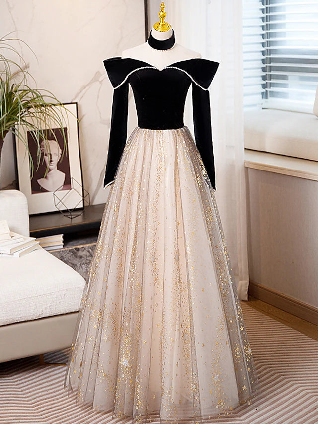Model wearing a sparkling A-line long sleeve prom dress with sweetheart neckline and sequin tulle.