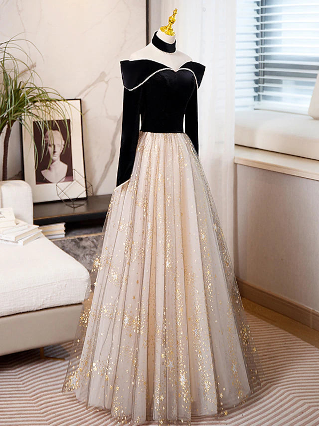 Back view of a model in a sparkling A-line long sleeve prom dress.