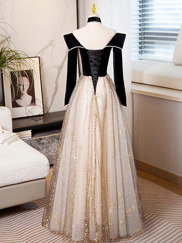 Full length view of a model in a shimmering A-line long sleeve formal gown.