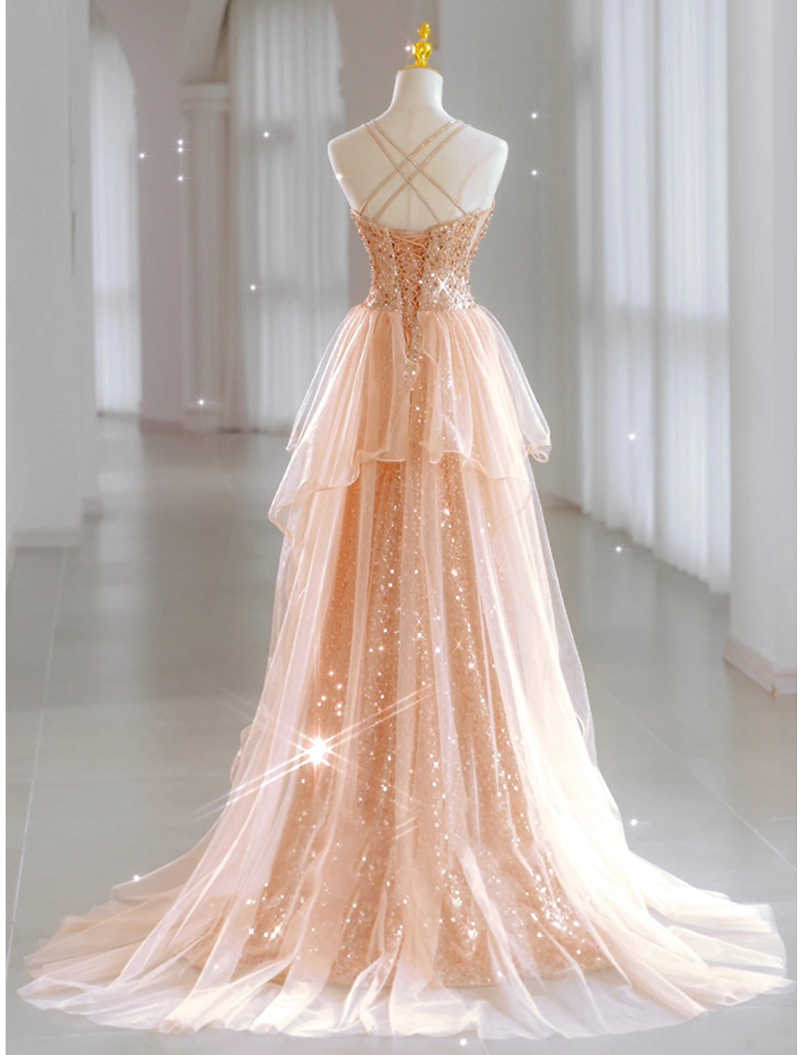 Back view of a floor-length sequin tulle A-line prom dress.