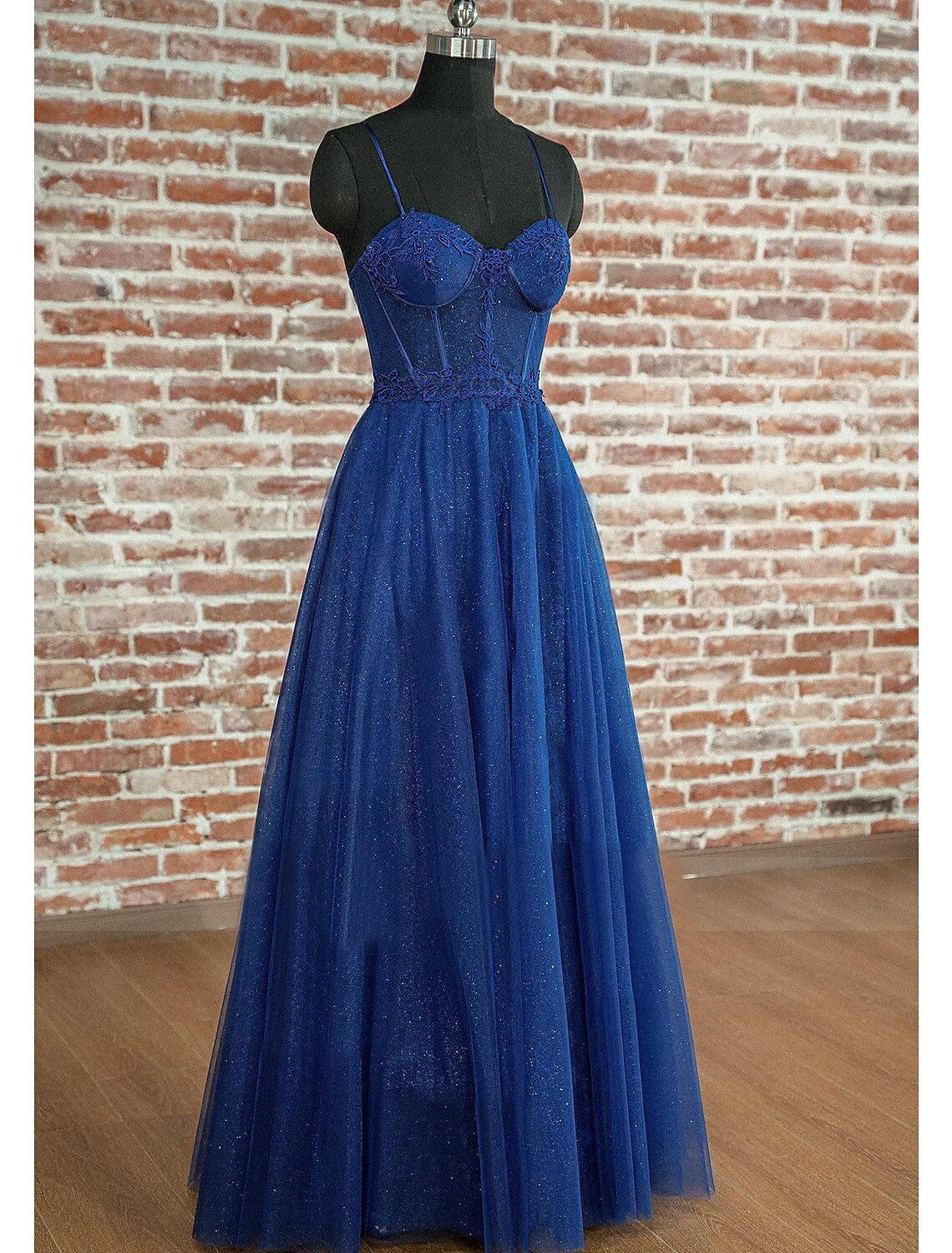 Side view of the A-line prom dress, showing pleats and floor length.