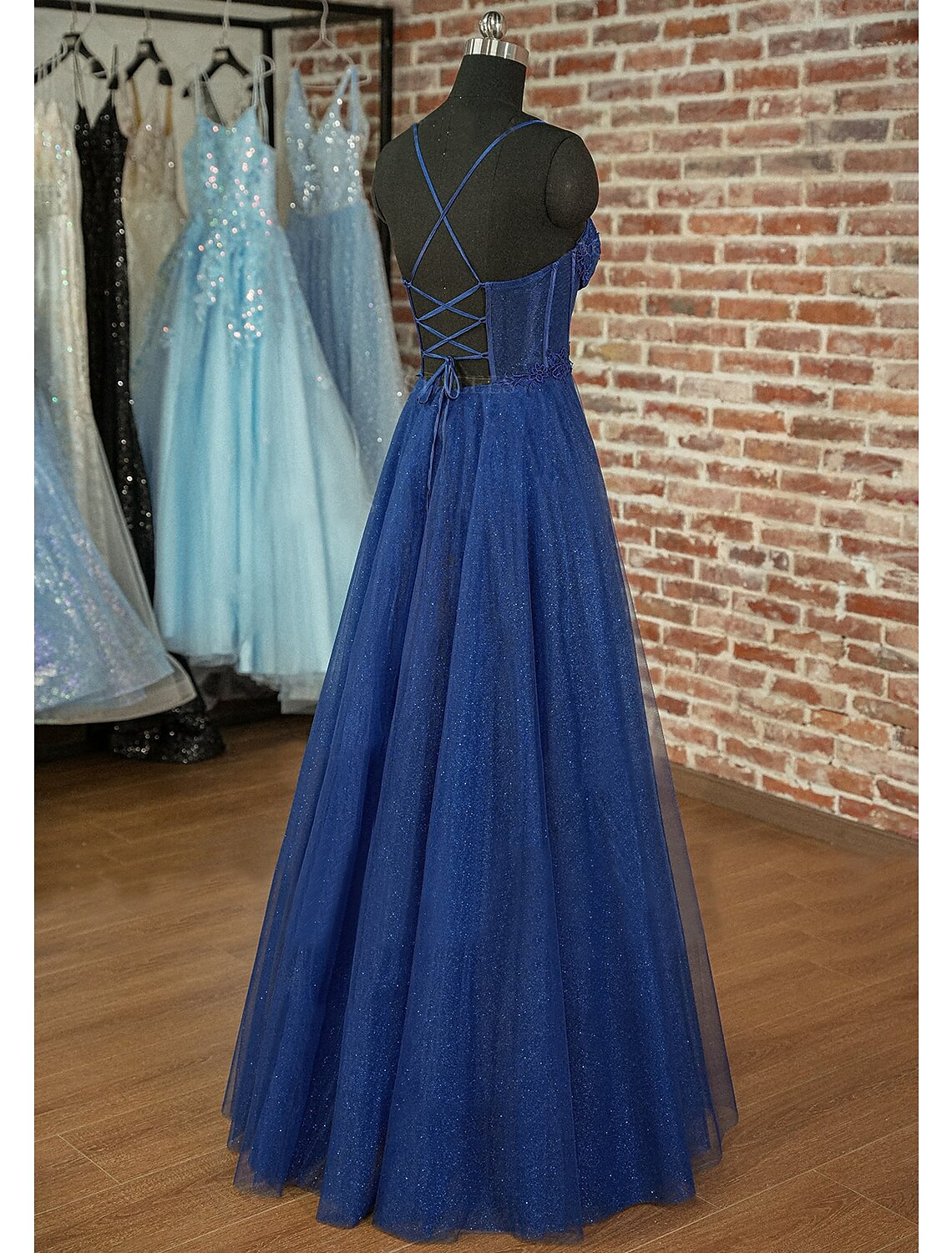 Close-up of the sparkling appliques and pleated details on the prom dress.