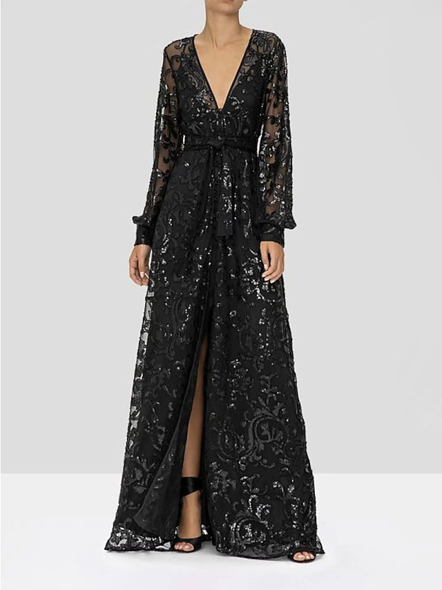 Back view of a model wearing a sparkling A-line V-neck long sleeve lace sequined floor-length gown.