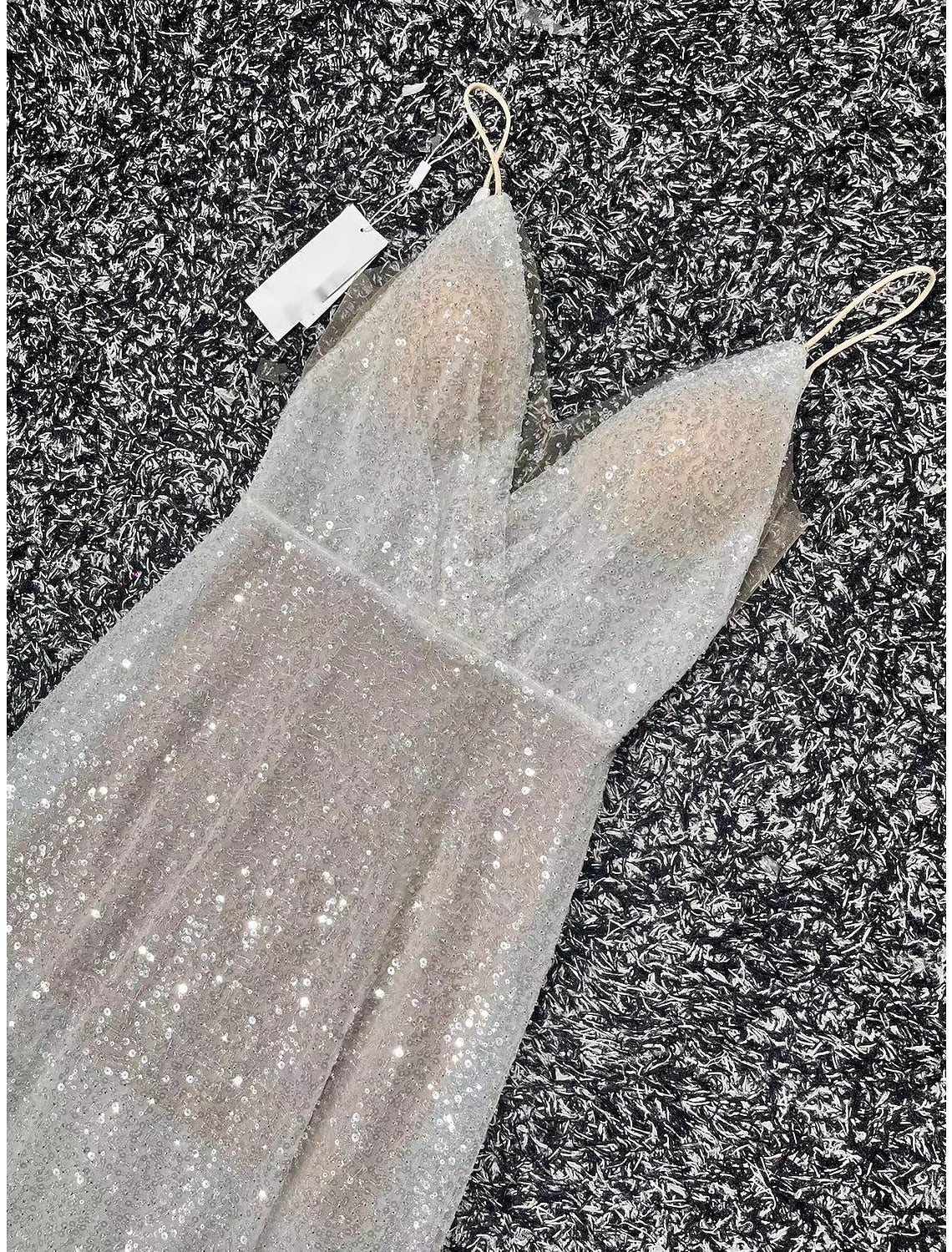 A-line sequined V-neck wedding dress with an open back and sweep train.