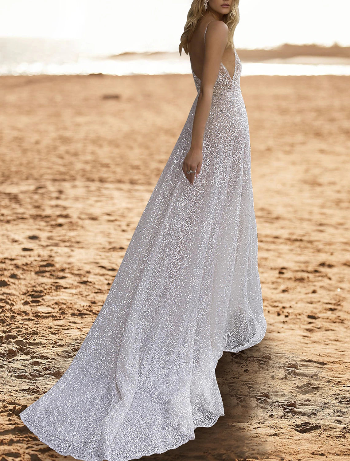 Side view of a sparkling sequined A-line bridal gown with a sweep train.