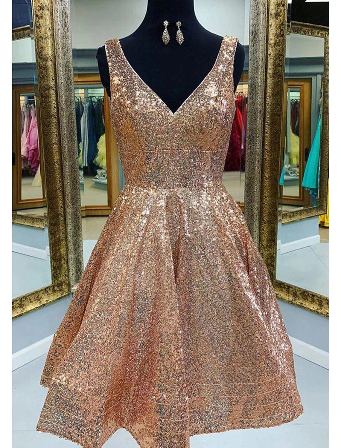 Model wearing a sparkling A-line V-neck sequined pink tea length homecoming dress.